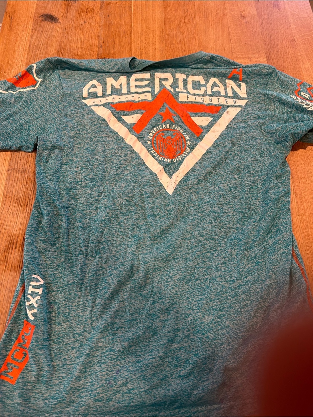 American Fighter Teal Short Sleeve Graphic Tee with Orange and White Logo